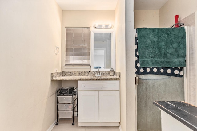 bathroom with tile patterned floors and vanity