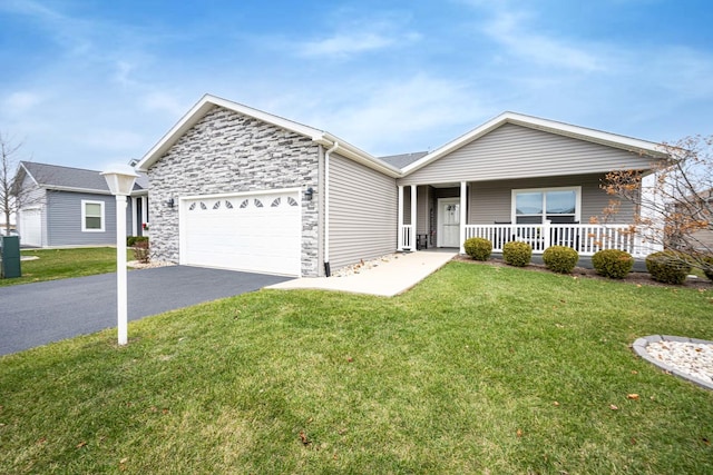 ranch-style house featuring covered porch, a front yard, and a garage