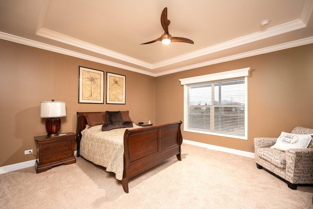 bedroom featuring ceiling fan, a raised ceiling, light colored carpet, and ornamental molding