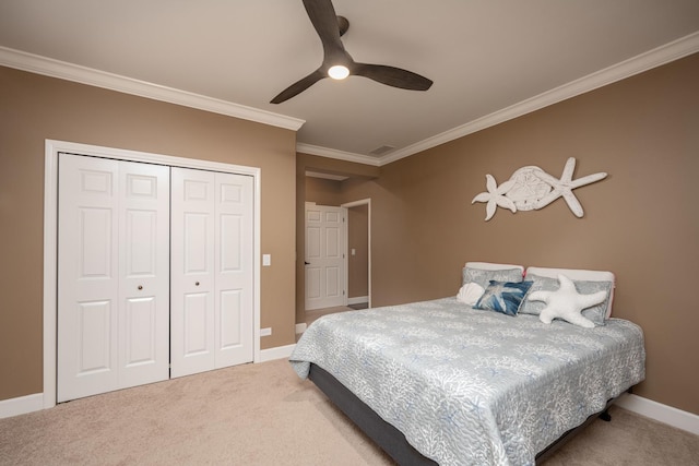 carpeted bedroom featuring a closet, ceiling fan, and ornamental molding