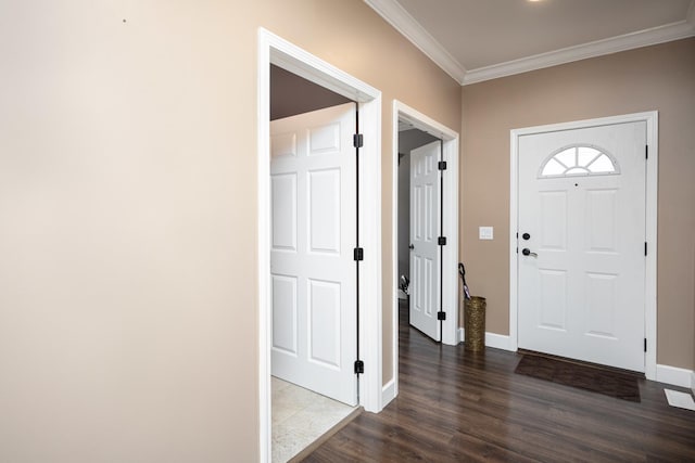 entrance foyer with dark hardwood / wood-style floors and ornamental molding