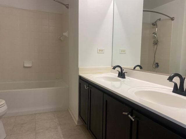 full bathroom with tile patterned flooring, vanity, toilet, and tiled shower / bath