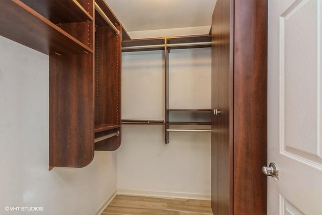 spacious closet featuring light hardwood / wood-style flooring