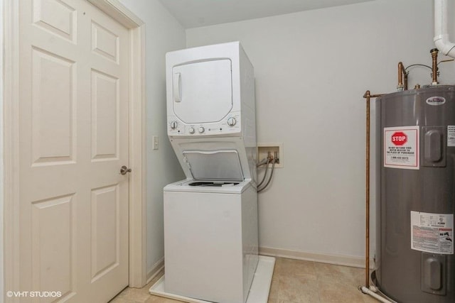 laundry room featuring electric water heater and stacked washer / dryer