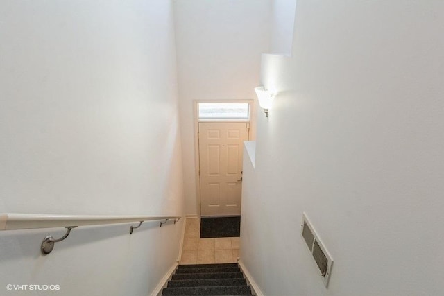 stairs featuring tile patterned flooring