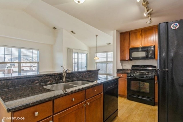 kitchen with black appliances, light hardwood / wood-style floors, lofted ceiling, and sink