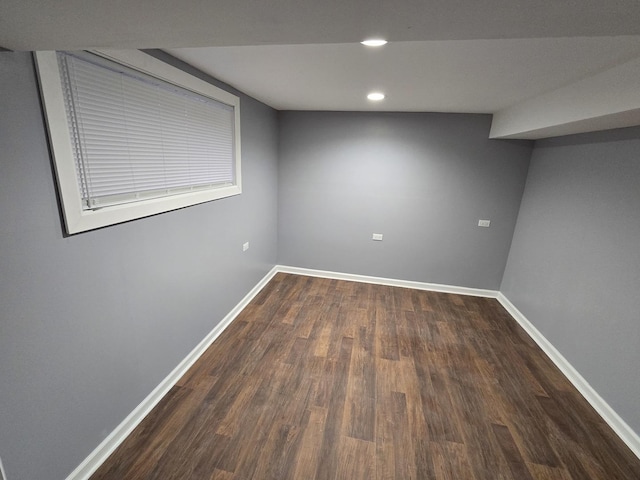 basement with dark hardwood / wood-style floors