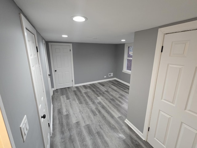 basement with light hardwood / wood-style flooring