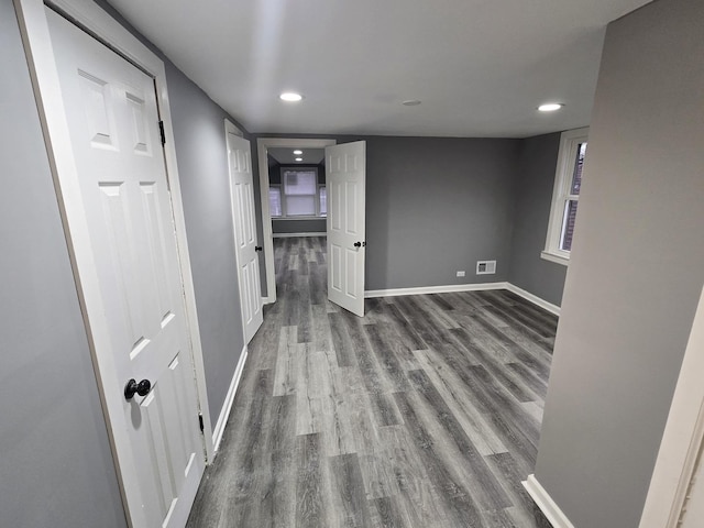 hallway with dark hardwood / wood-style floors