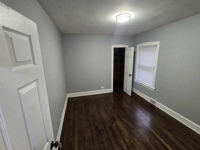 spare room with dark hardwood / wood-style flooring