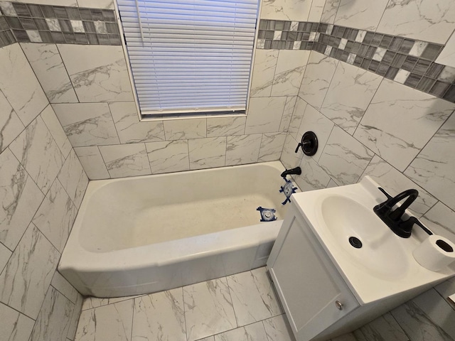 bathroom with vanity and tile walls