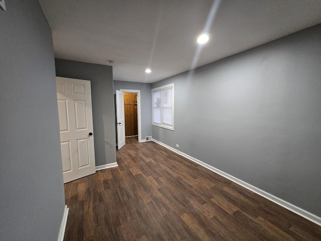 empty room featuring dark hardwood / wood-style flooring