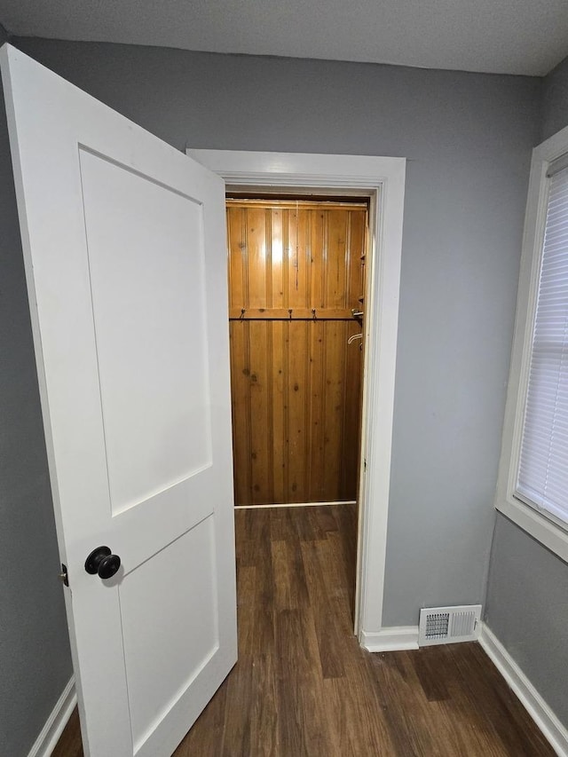 hallway with dark wood-type flooring