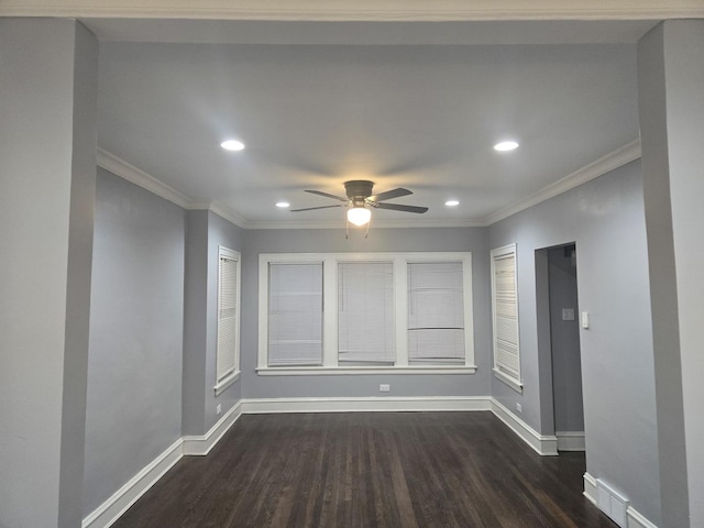 empty room with dark hardwood / wood-style floors, ceiling fan, and crown molding