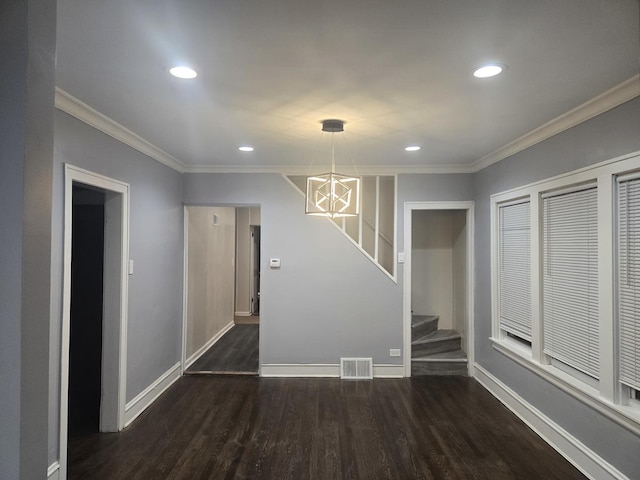 unfurnished dining area with a notable chandelier, dark hardwood / wood-style floors, and ornamental molding