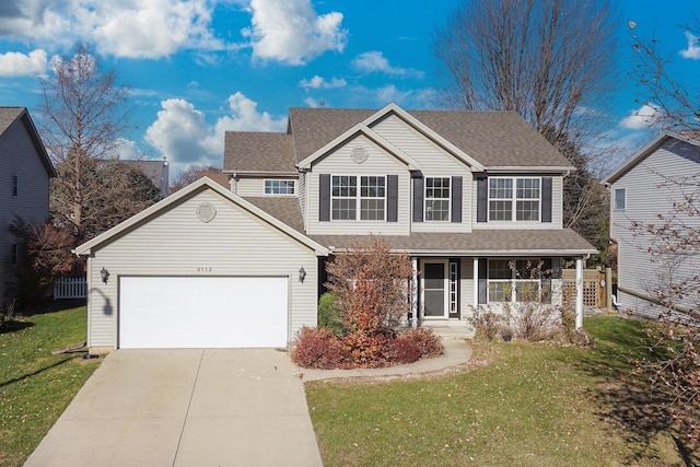 view of property featuring a porch, a garage, and a front yard