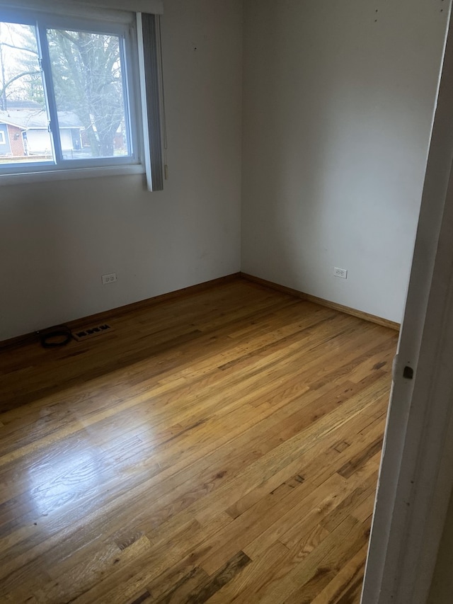 empty room with light hardwood / wood-style floors