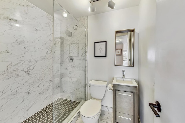 bathroom featuring vanity, toilet, and a marble finish shower