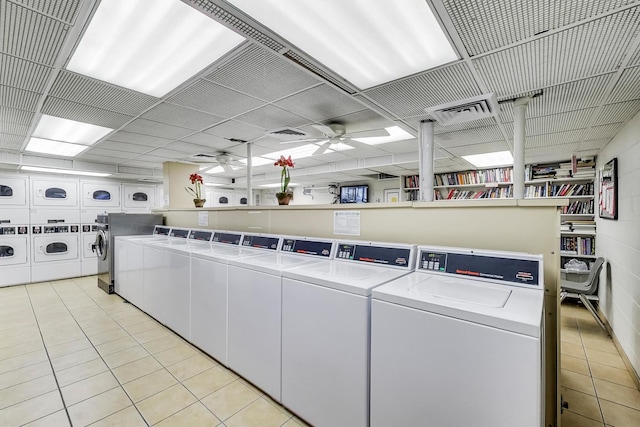 common laundry area with light tile patterned floors, visible vents, separate washer and dryer, and ceiling fan