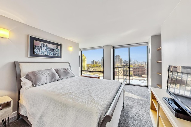 bedroom with expansive windows, carpet floors, and access to outside