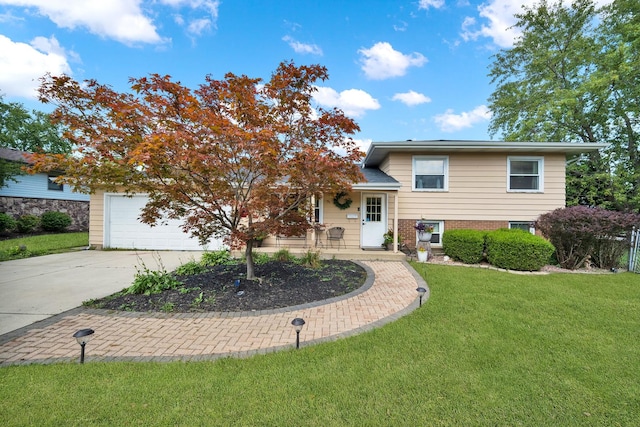 split level home with a garage and a front lawn