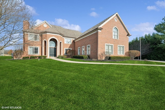 view of property featuring a front lawn