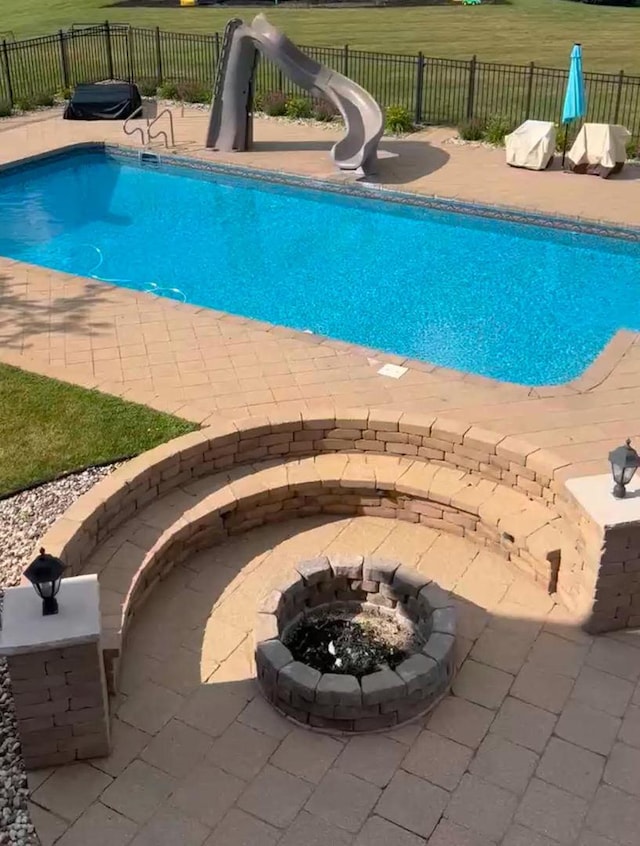 view of pool with a patio area and a water slide