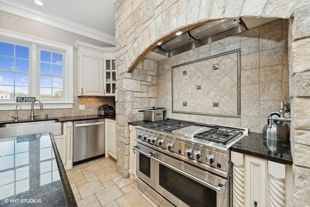 kitchen featuring white cabinets, sink, decorative backsplash, ornamental molding, and appliances with stainless steel finishes