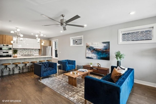 living room with dark hardwood / wood-style floors and ceiling fan