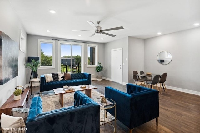 living room featuring ceiling fan and dark hardwood / wood-style flooring