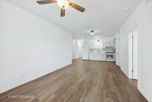 unfurnished living room with hardwood / wood-style flooring and ceiling fan