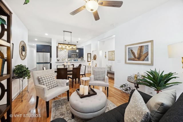 living room featuring ceiling fan and light wood-type flooring