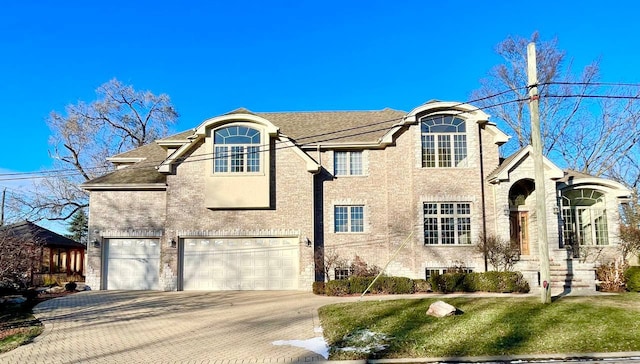 french country inspired facade with a front lawn and a garage