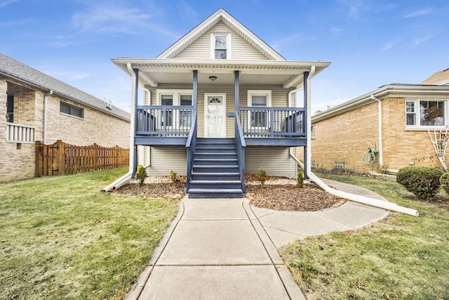 view of front of home with a porch and a front yard