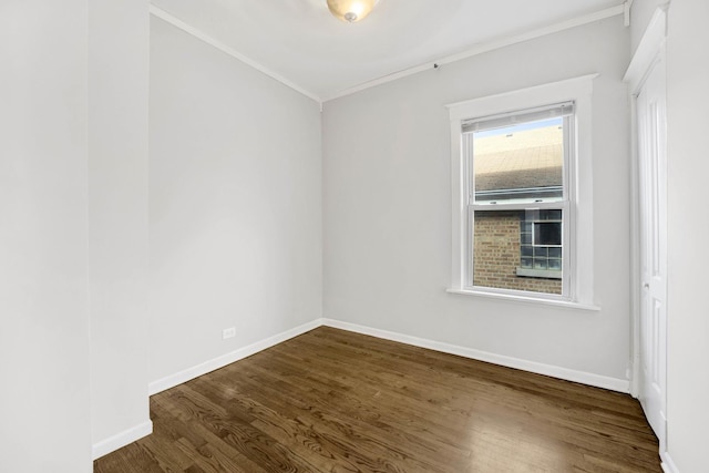 unfurnished room with dark hardwood / wood-style floors and crown molding