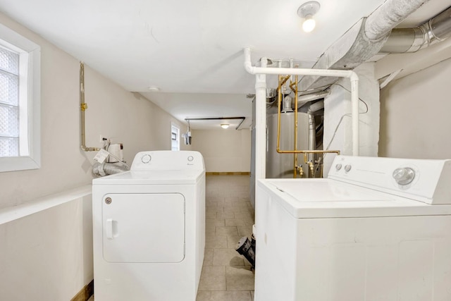 laundry area featuring independent washer and dryer, gas water heater, and light tile patterned floors