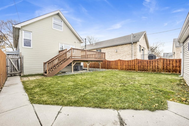 exterior space with central air condition unit, a deck, and a lawn