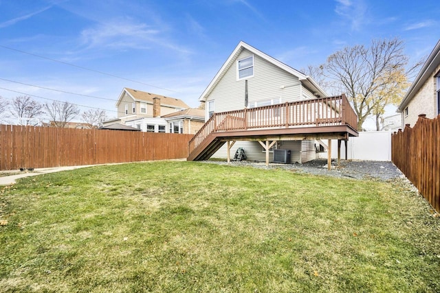 rear view of property featuring central air condition unit, a yard, and a deck