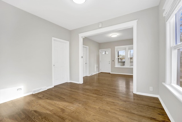 unfurnished room with dark wood-type flooring