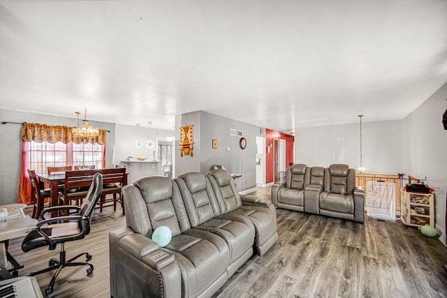 living room with a chandelier and hardwood / wood-style flooring