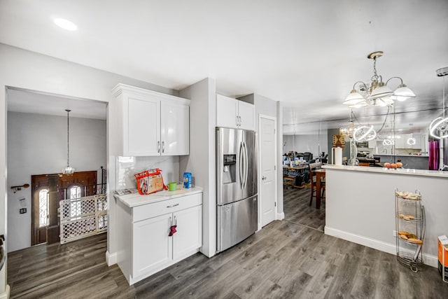 kitchen featuring white cabinetry, stainless steel fridge, and dark wood-type flooring