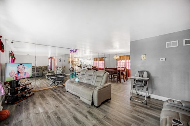 living room with a chandelier and hardwood / wood-style flooring