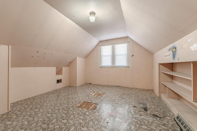 additional living space featuring vaulted ceiling