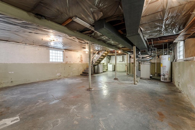 basement with heating unit, washer / dryer, and gas water heater