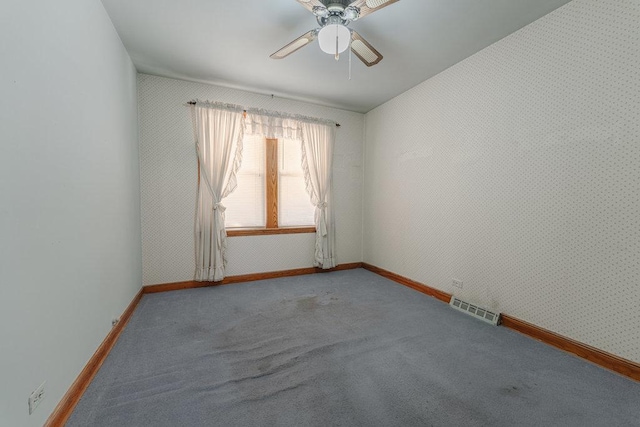 carpeted empty room featuring ceiling fan