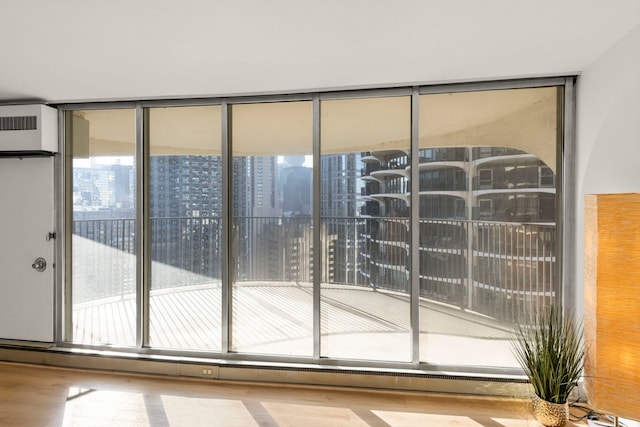 entryway with expansive windows and wood finished floors