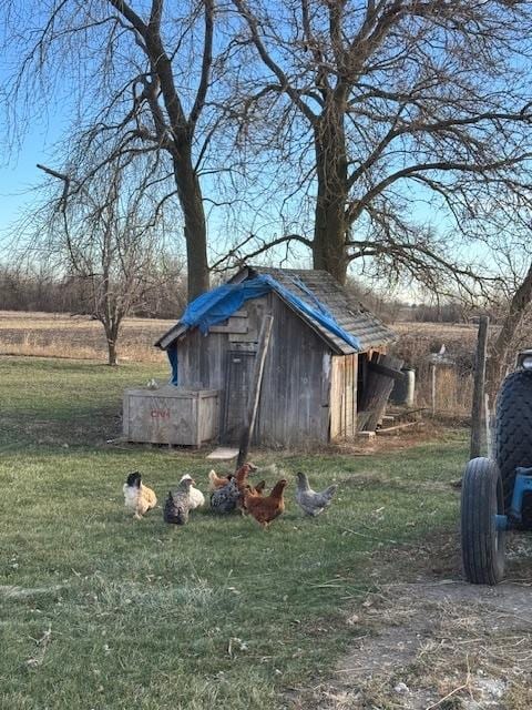 view of outbuilding with a lawn