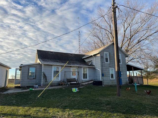 back of house with a lawn