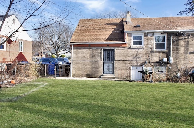 rear view of house with a lawn