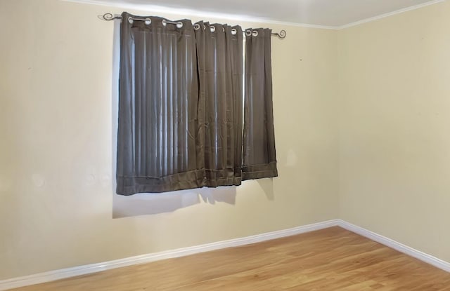 unfurnished room featuring crown molding and hardwood / wood-style flooring